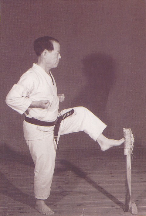 Osensei Nagamine practising kicks on makiwara Osensei Nagamine practising kicks on makiwara